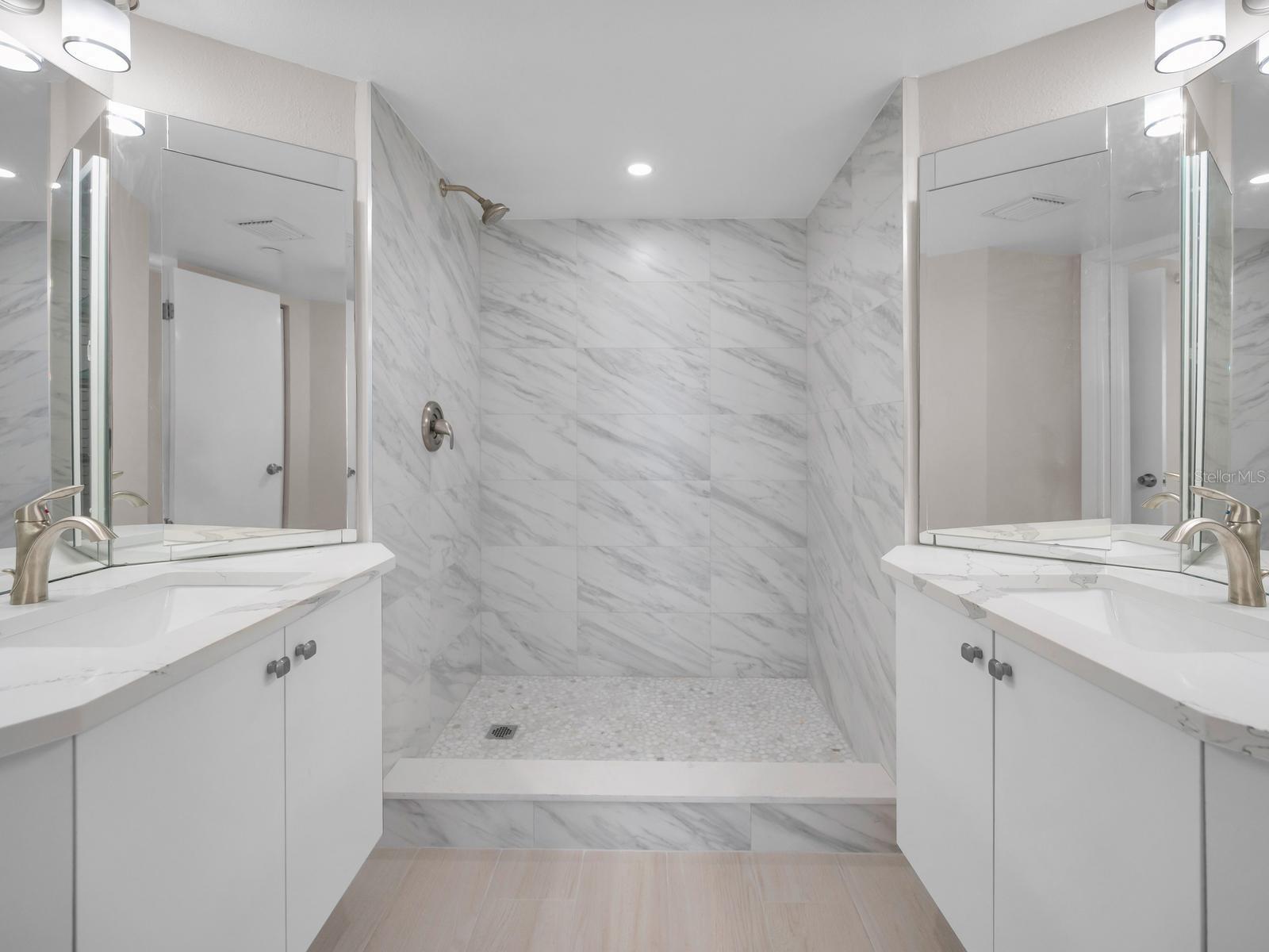 Modern Bath Features a Spectacular Spacious Walk-In Shower, Dual Sink Vanities with Moen Fixtures.