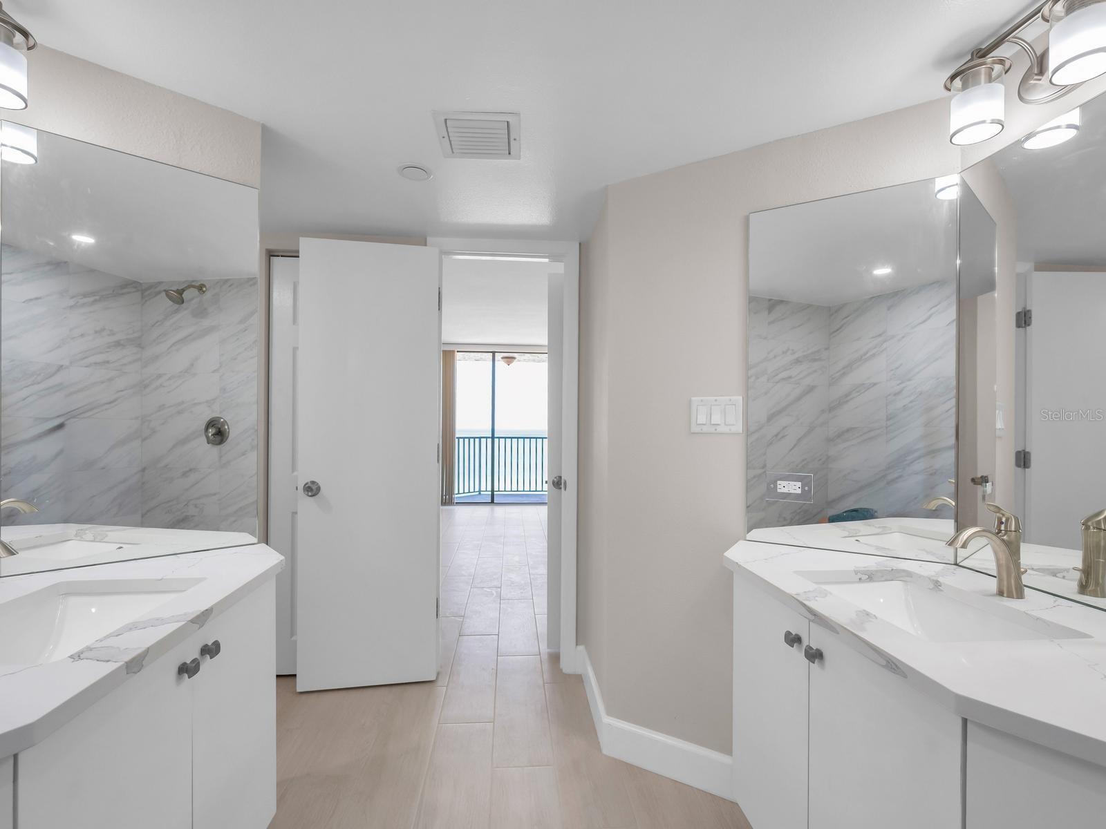 Modern Bath Features a Spacious Walk-In Shower, Dual Sink Vanities with Moen Fixtures!