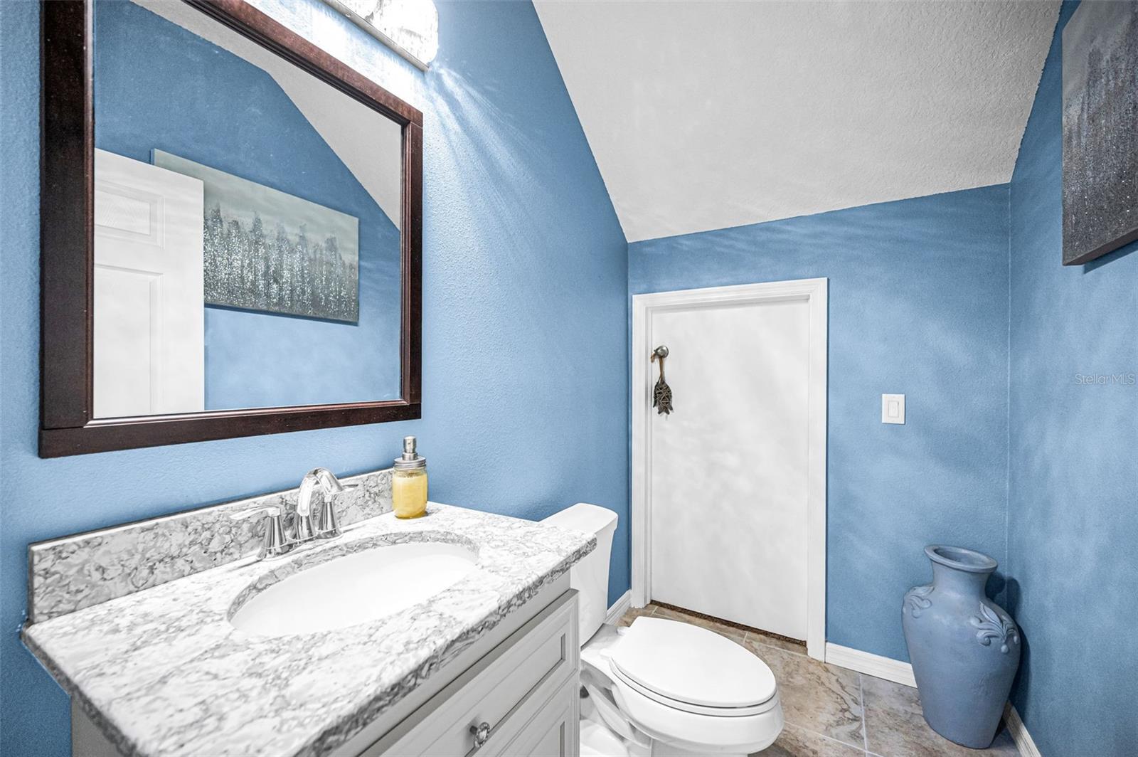 large under-stair storage area in the downstairs half bath.