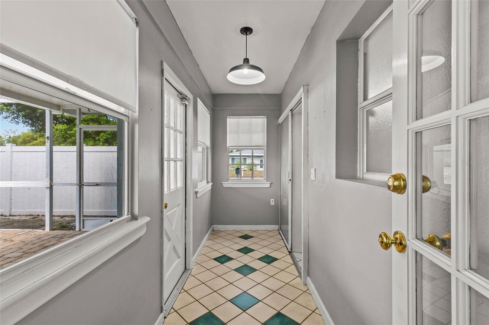 Hallway to second full bath, laundry and pool