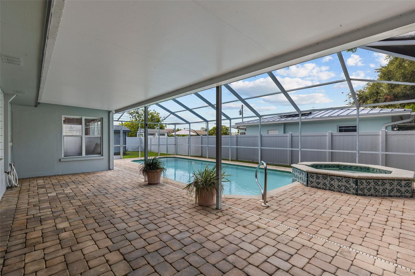 Outside covered pool deck with pavers