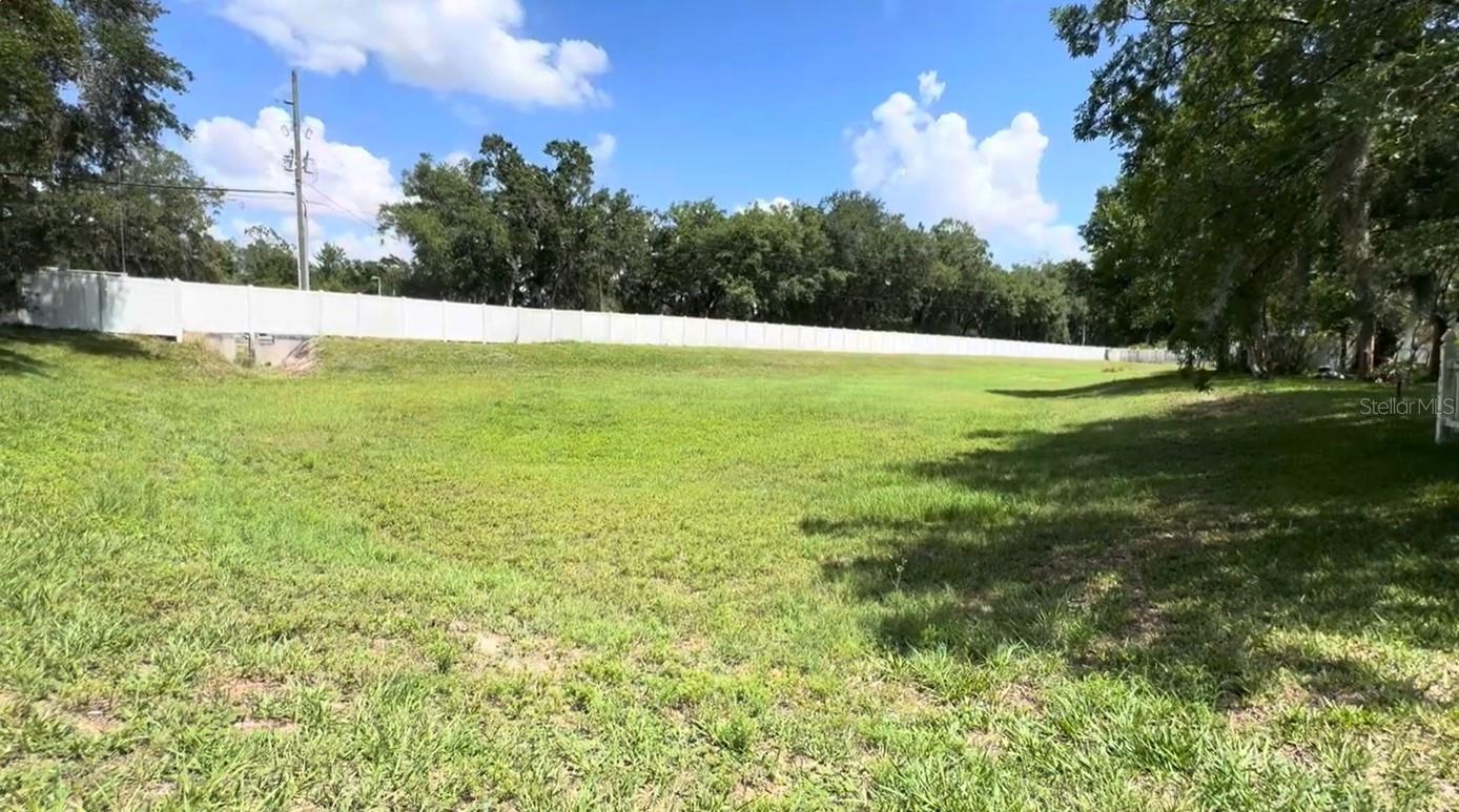Fenced in backyard has access to a multi-care fenced in easement area
