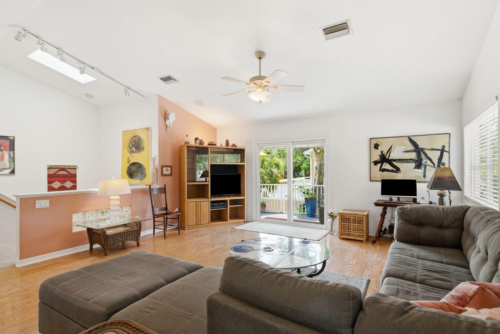 Living room with skylight over stairs.