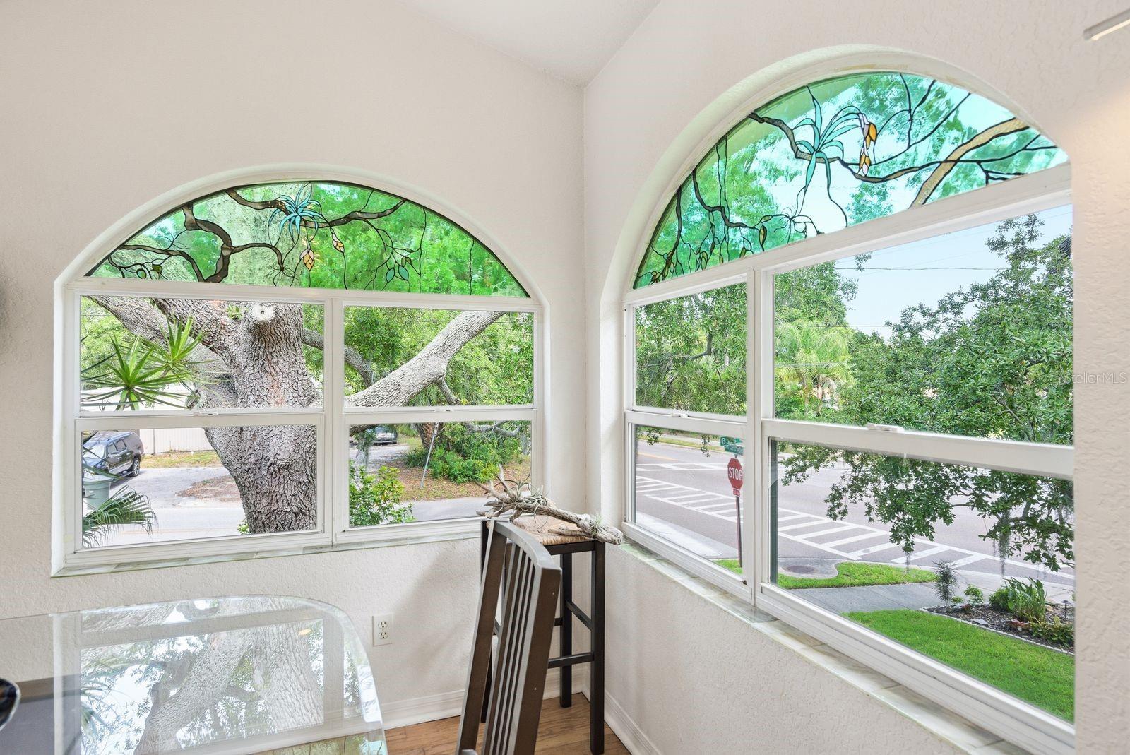 Windows have custom stained glass created to mimic the oak tree coming in from the outside and windowsills lined with custom handmade fused glass tiles.