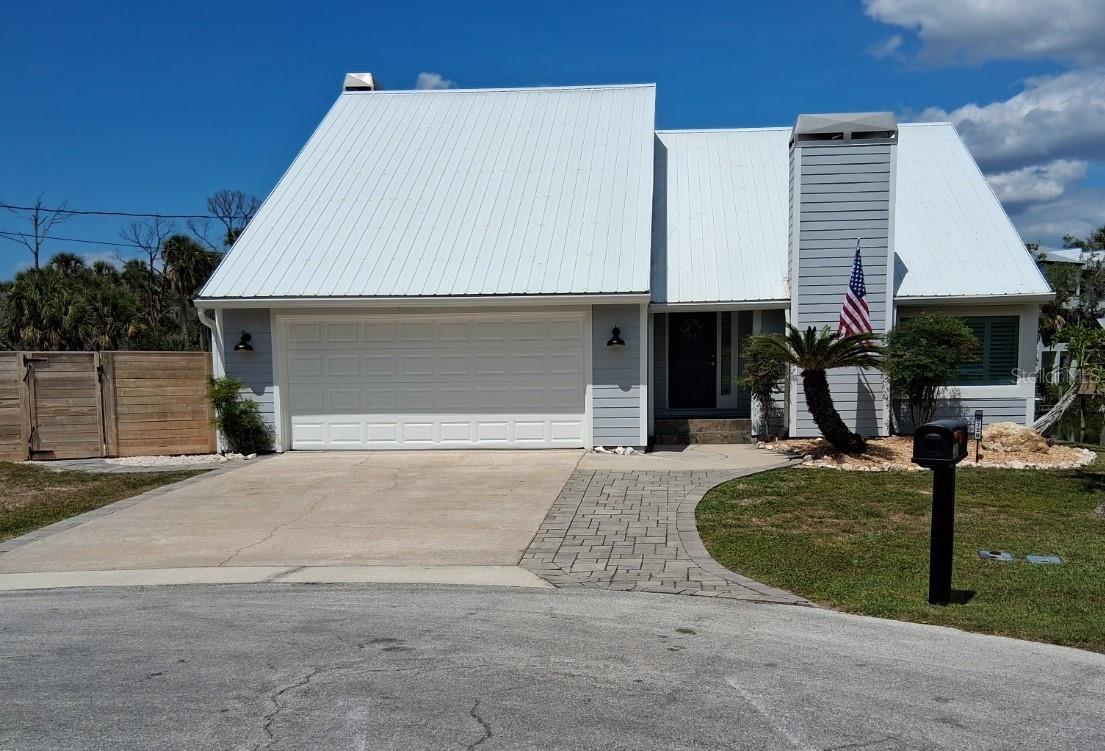 Clean, modern, unique front elevation - love the very long-lasting metal roof!
