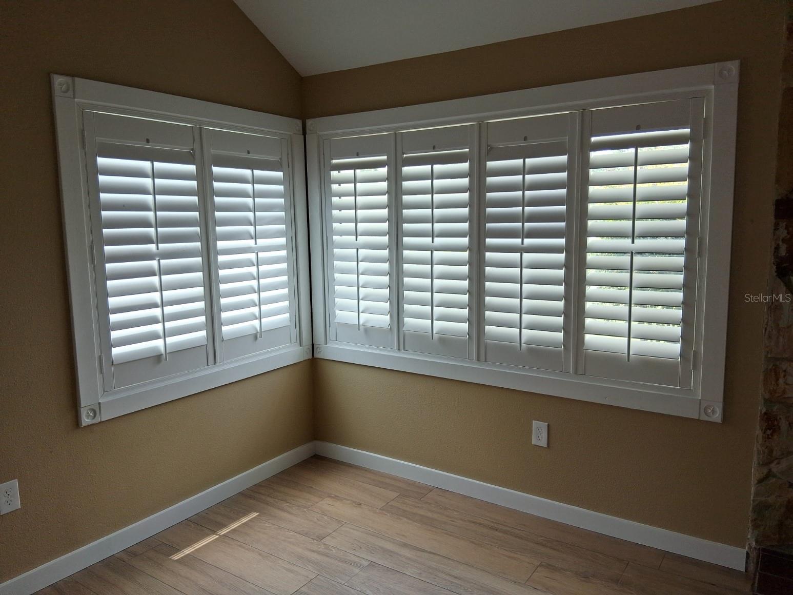 Close-up of living rm windows - all windows and French doors are high-end, hurricane resistant, double pane. Love the plantation shutters!