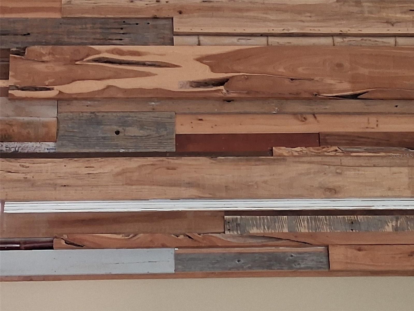 Close-up of the wood plank & metal décor on the loft rail wall.