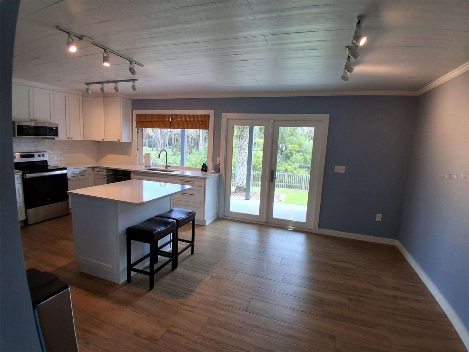 Dining area with high-end, dbl pane French doors out to covered porch.