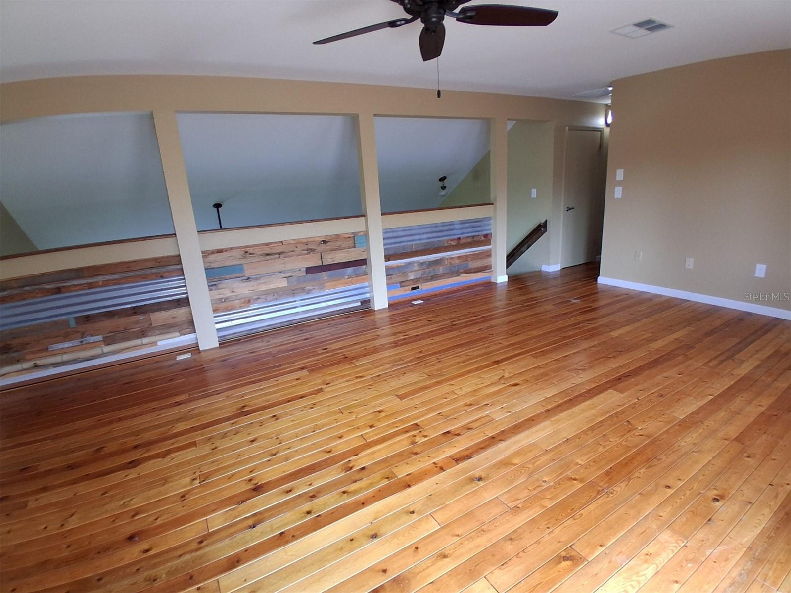 View from French doors - again, the very creative wood plank and metal décor of the rail wall overlooking the living room.
