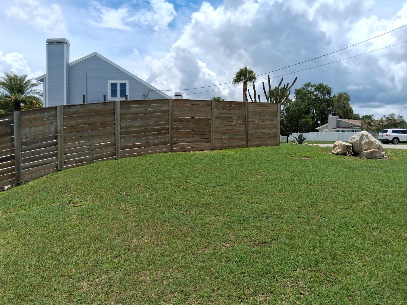 Side yard to the left - showing natural elevation