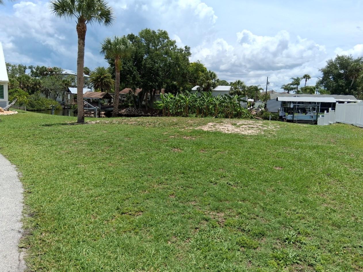 Vacant lot adjacent on the right included in list price is .16 acres with 152' canal frontage.