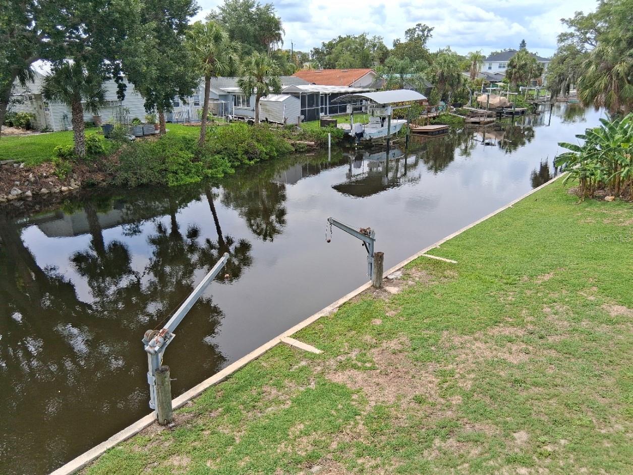 View of the right side canal and the included adjacent lot. Davits are not functional.