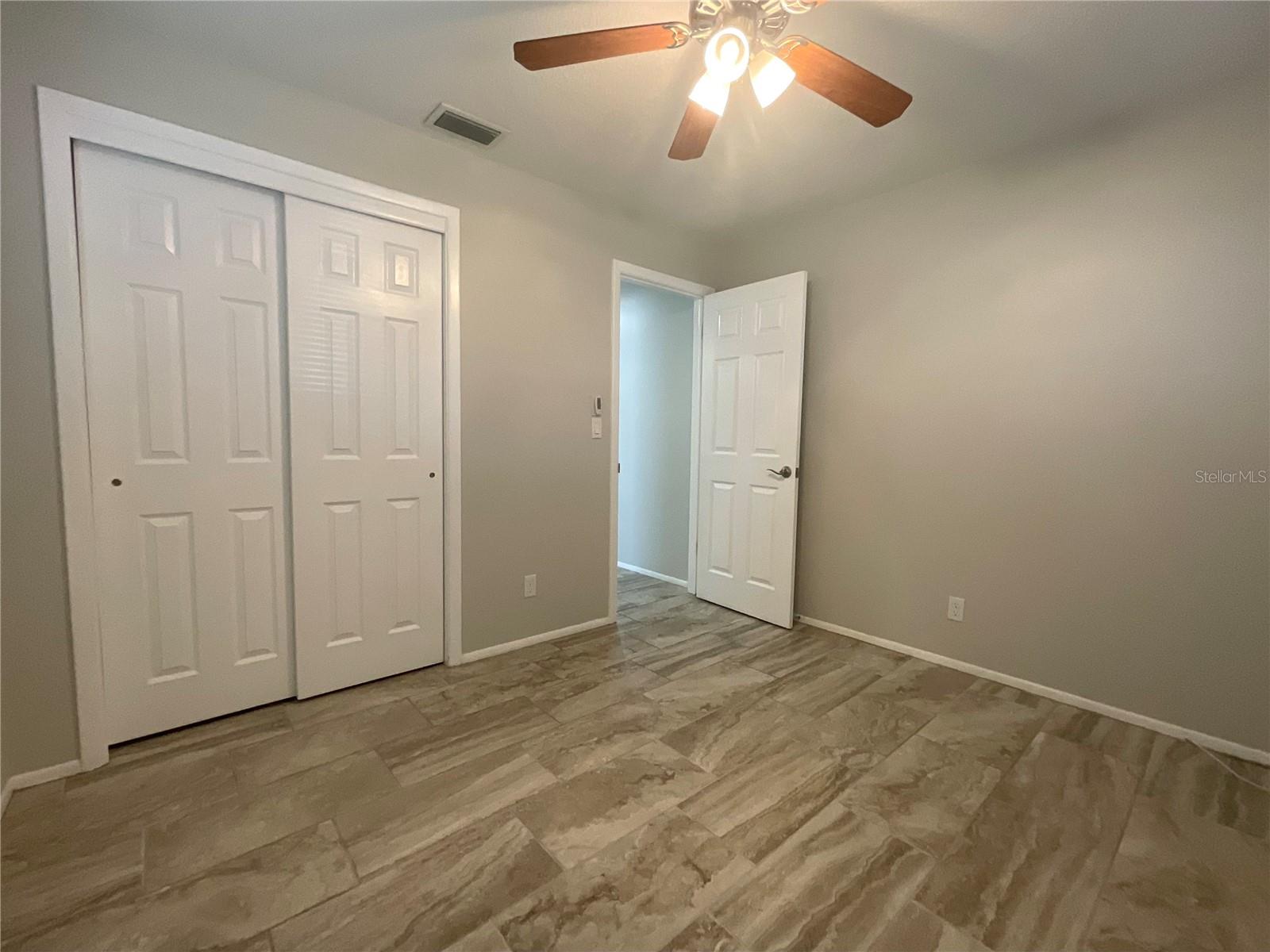 Guest bedroom built-in closet and door to hallway