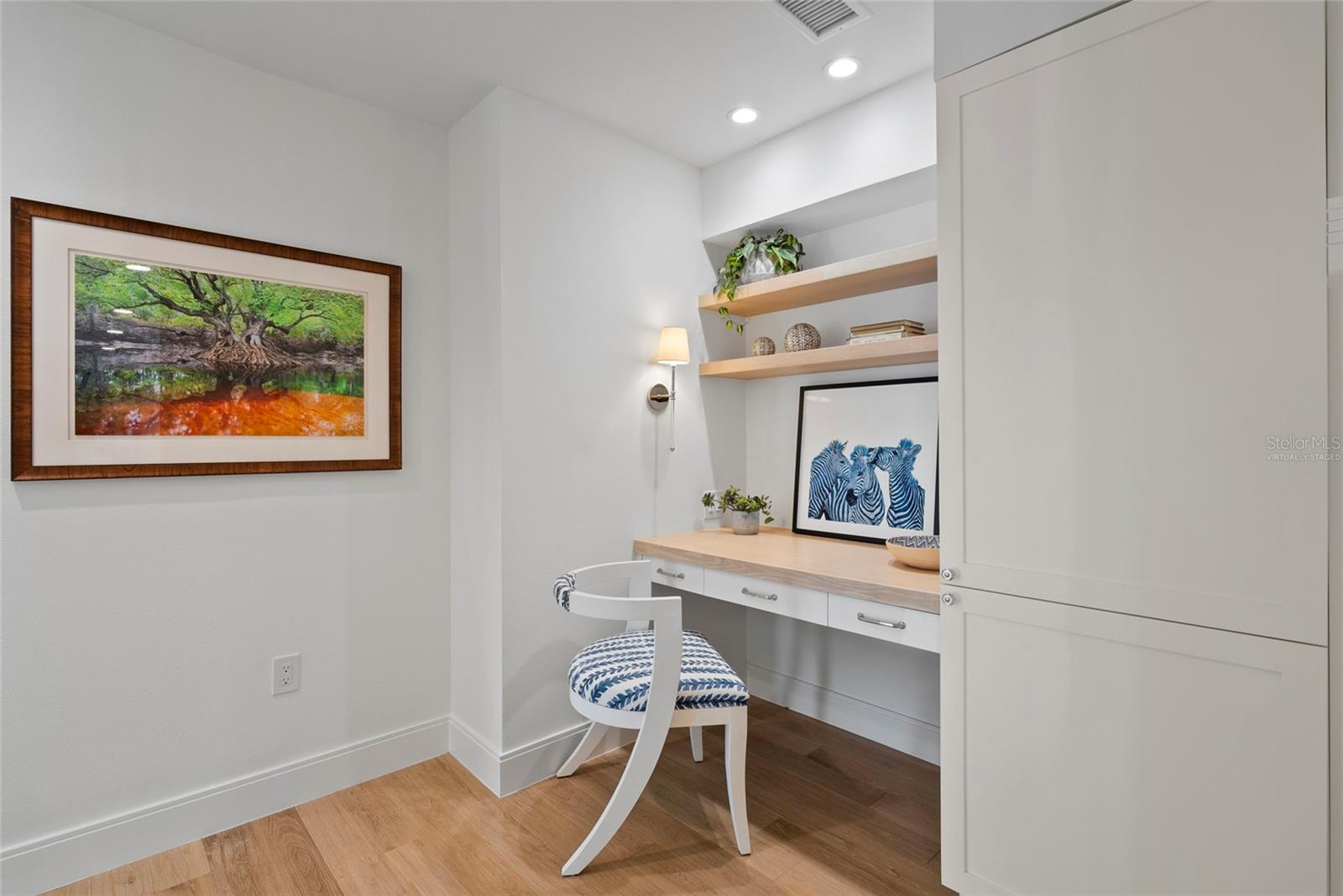 Master suite office area with shell stone tile, virtually staged
