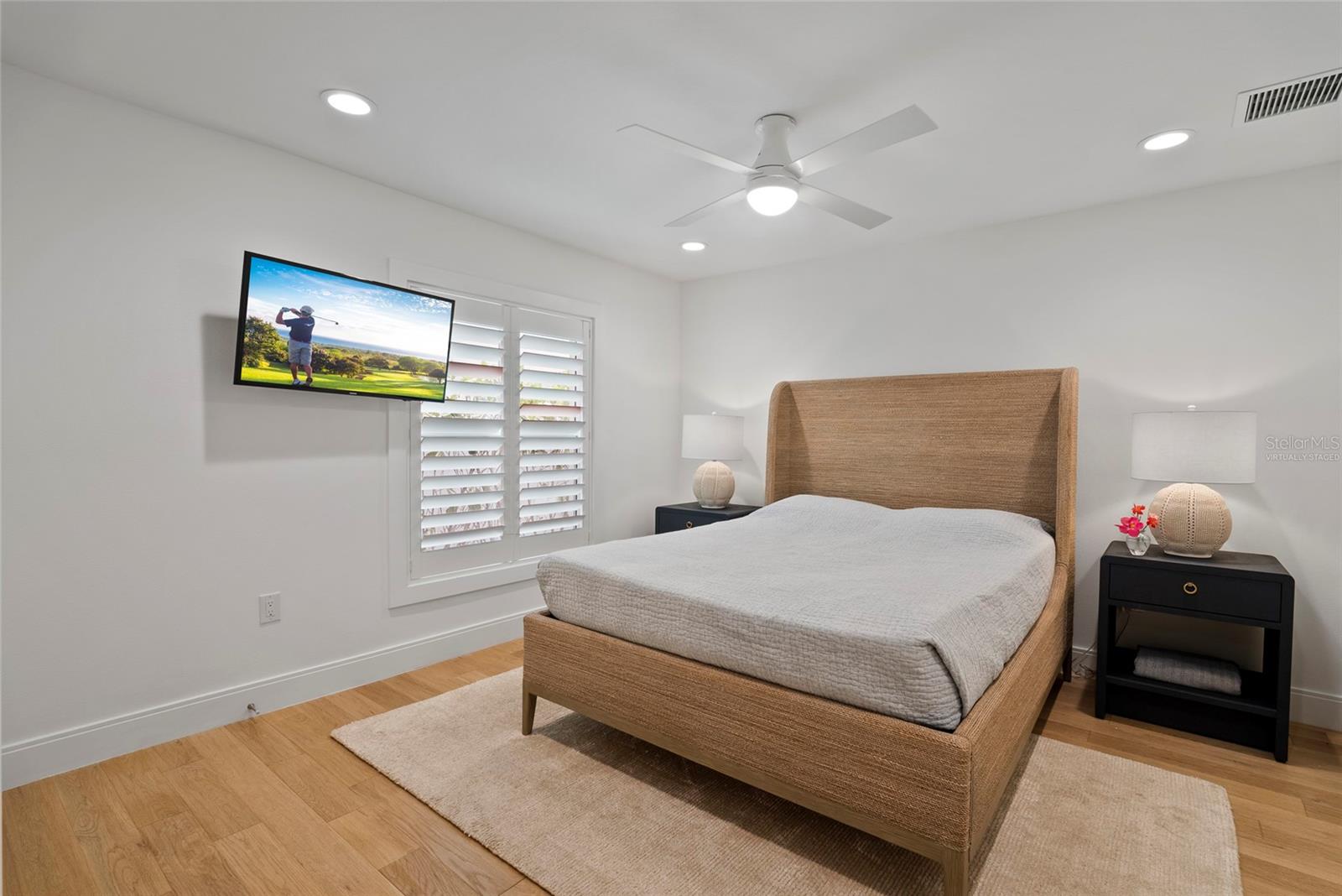 5th bedroom guest suite w/ shell stone flooring and pocket door for suite privacy, virtually staged