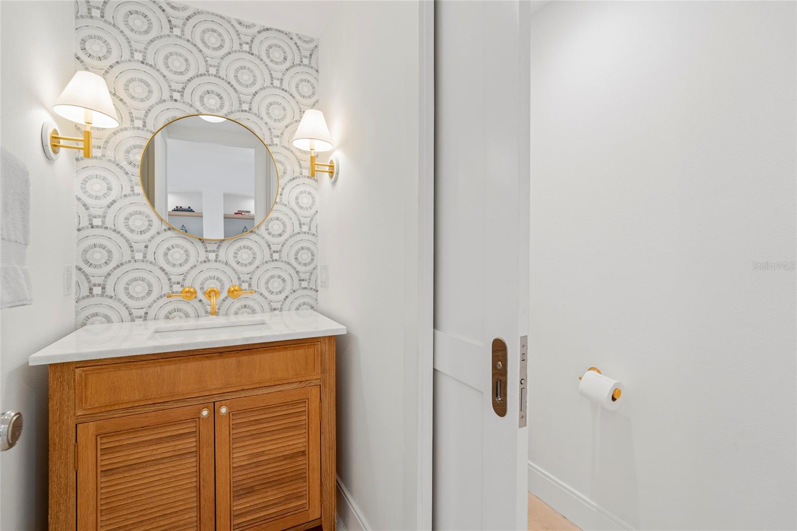 Powder room w/mosaic tile backsplash, upscale fixtures and lighting