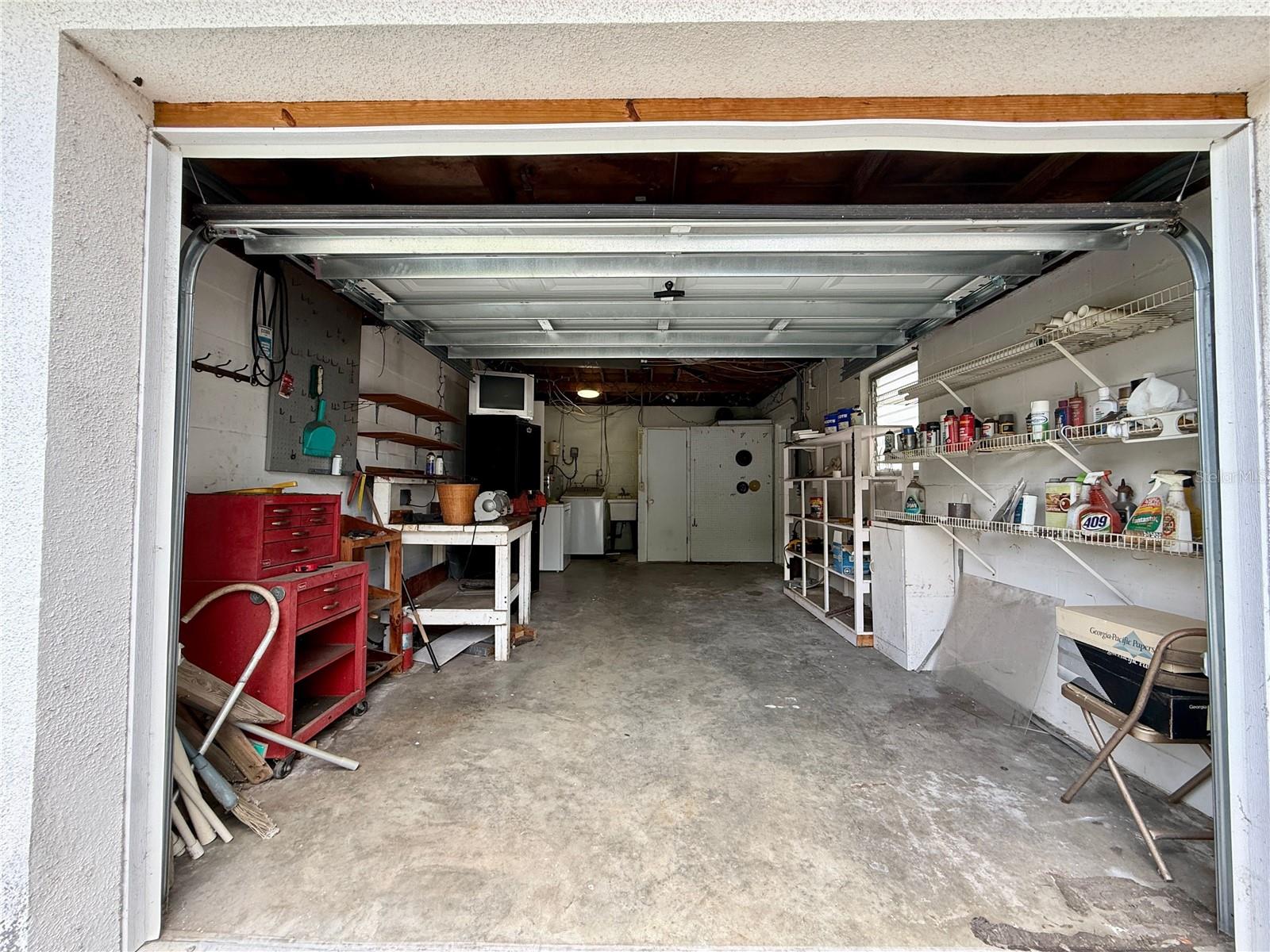 Put up a wall to have inside laundry and access to the 2nd full bathroom. You still have 17 ft in the garage.