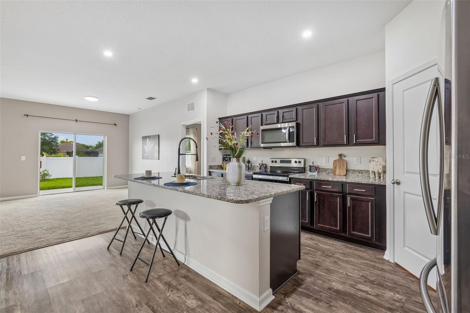 Hugh Kitchen features Oversized Island upgraded faucet and walk in pantry