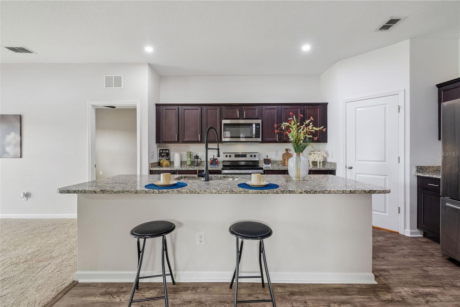 Hugh Kitchen features Oversized Island upgraded faucet and walk in pantry