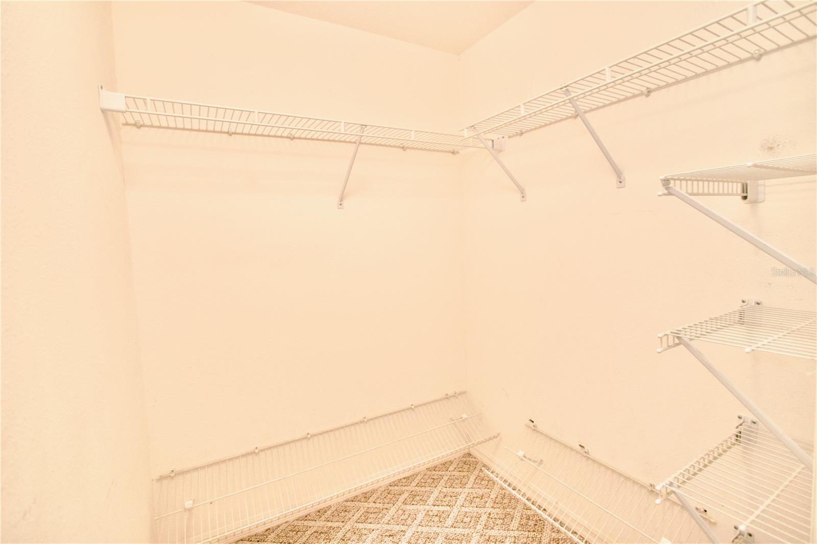 One of Two Walk-In Closets in Primary Bedroom