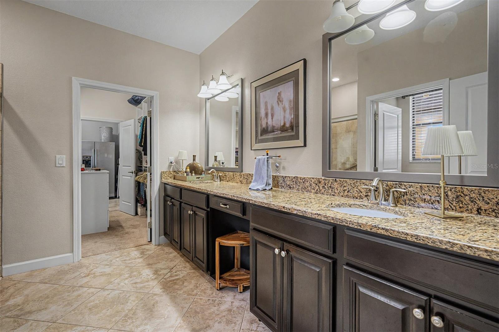 Primary bathroom with dual sinks, vanity area and large shower