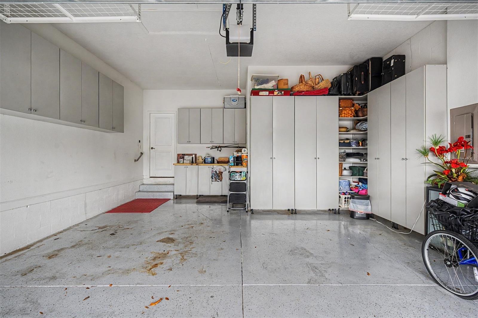 Garage with LOADS of storage cabinets and newly painted garage floor