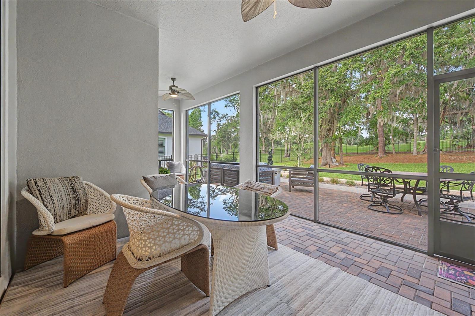 Screened back lanai overlooking backyard & golf course