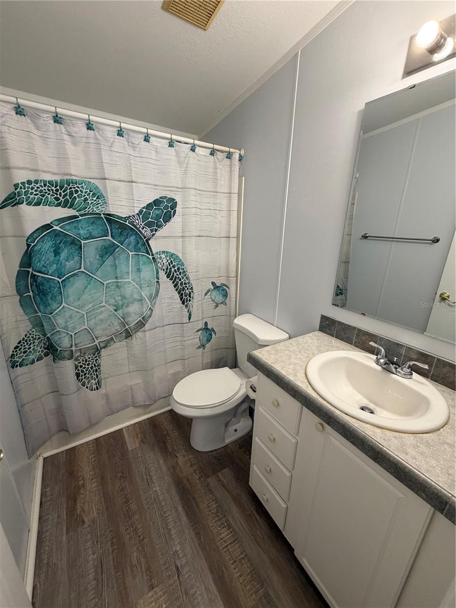 Guest Bath features shower tub combo and close to guest bedroom.