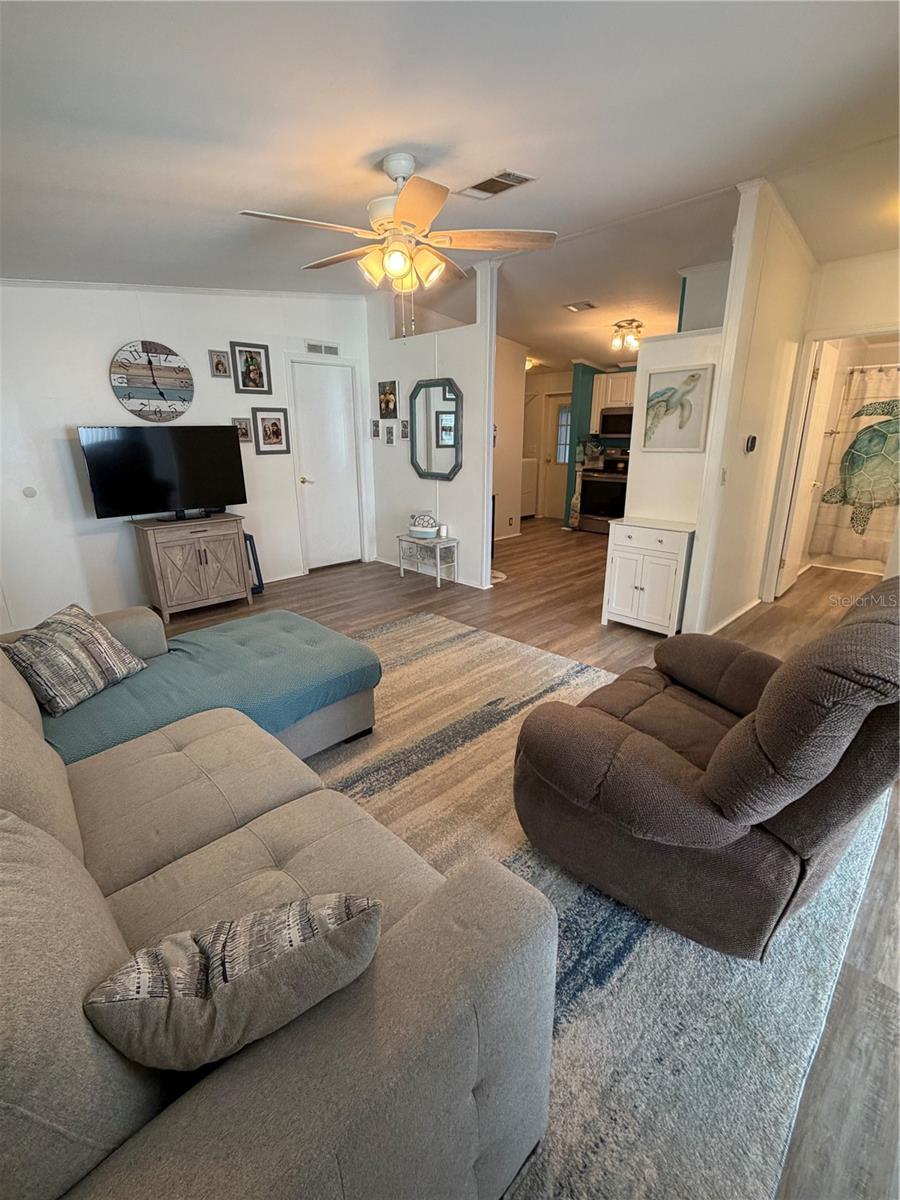 Across living room to kitchen.