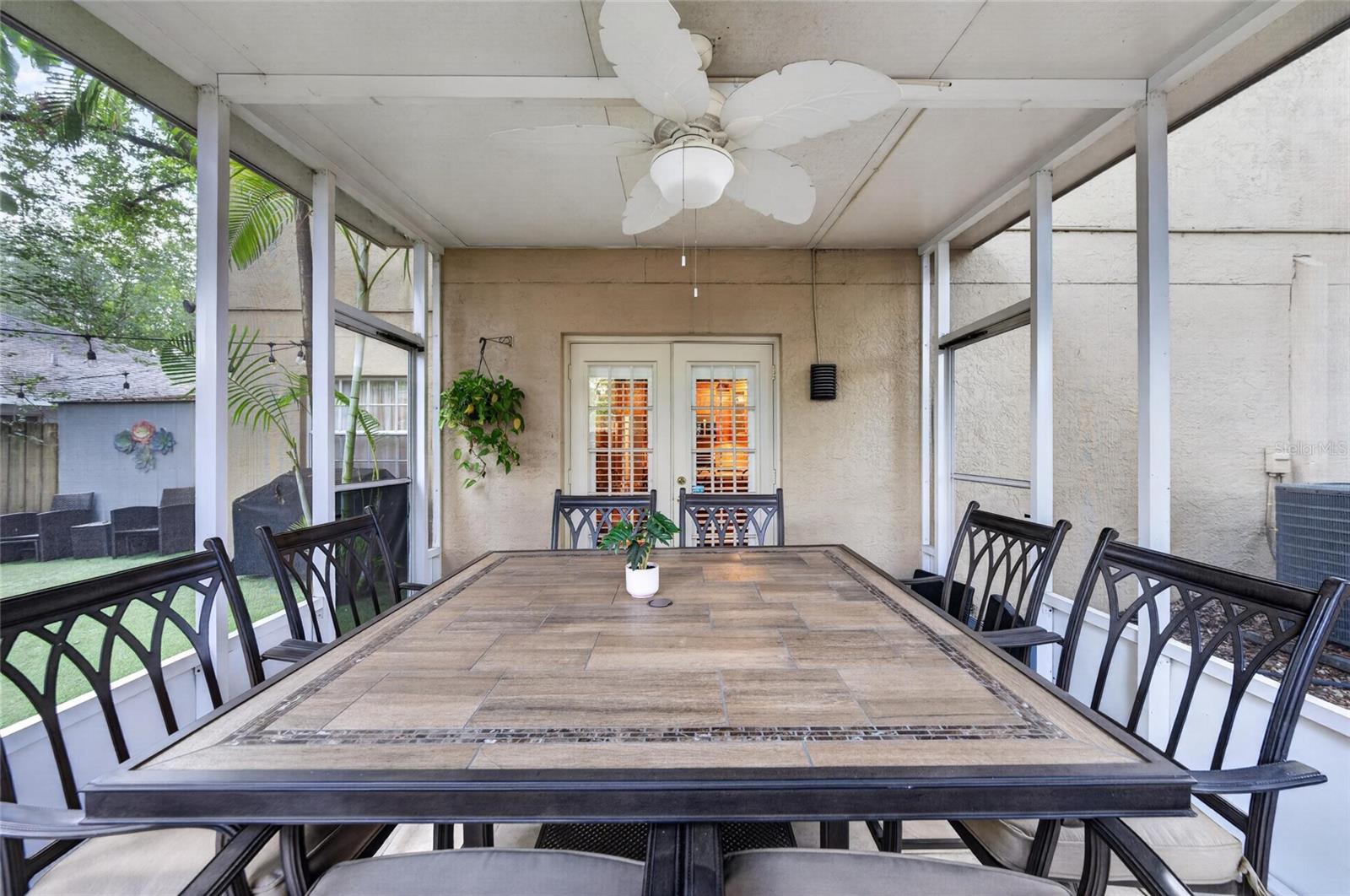 SCREENED IN PATIO OFF OF KITCHEN AREA