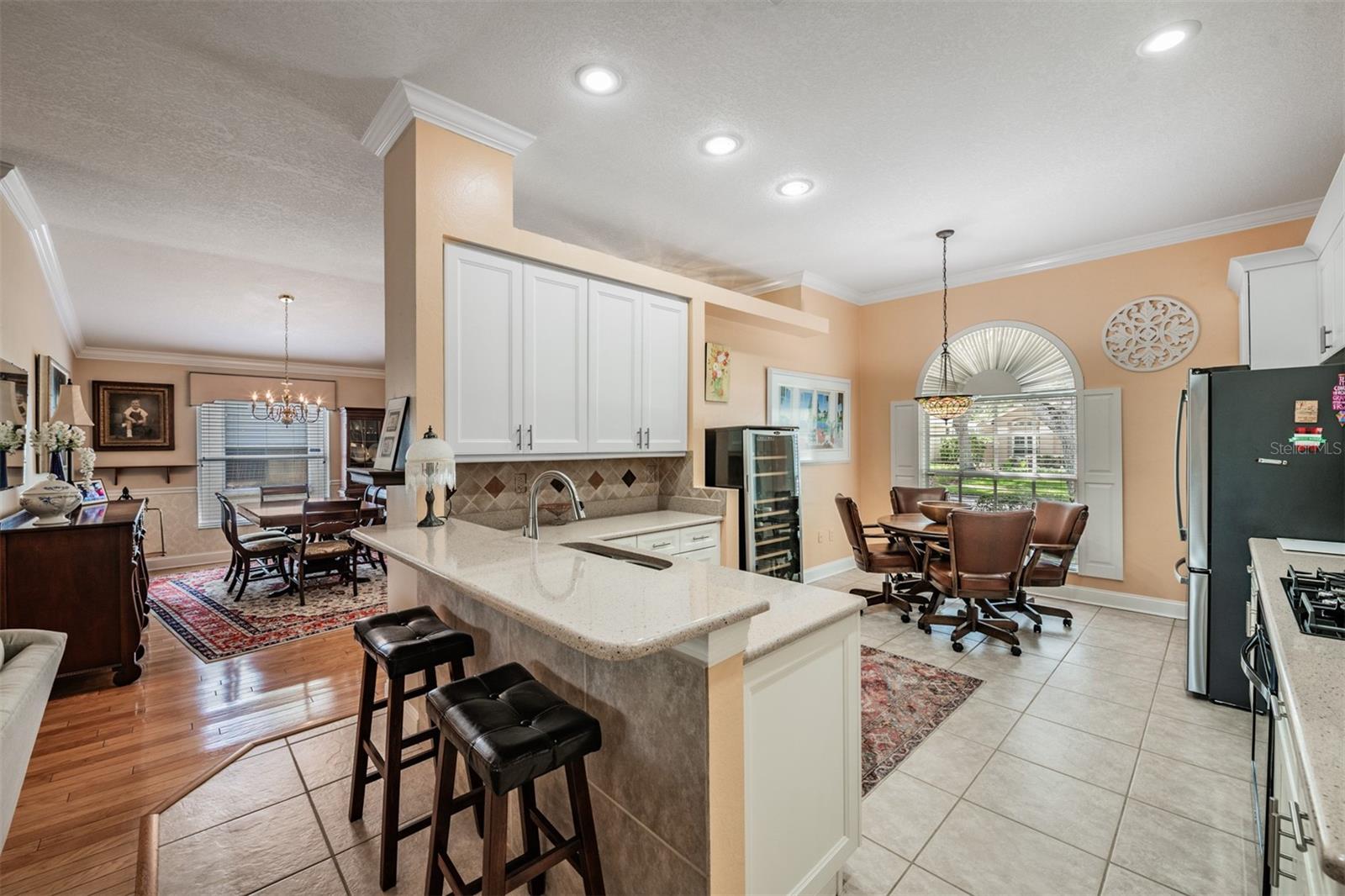 Open Kitchen to the Family Room, Tile Flooring, Inset Lighting and lots of sunlight.