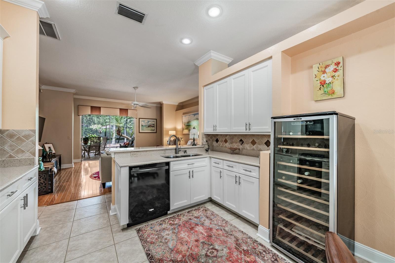 Open Kitchen to the Family Room, Stone Countertops, Stainless Steel Appliances, Gas Range, Tile Flooring, Inset Lighting and lots of sunlight.