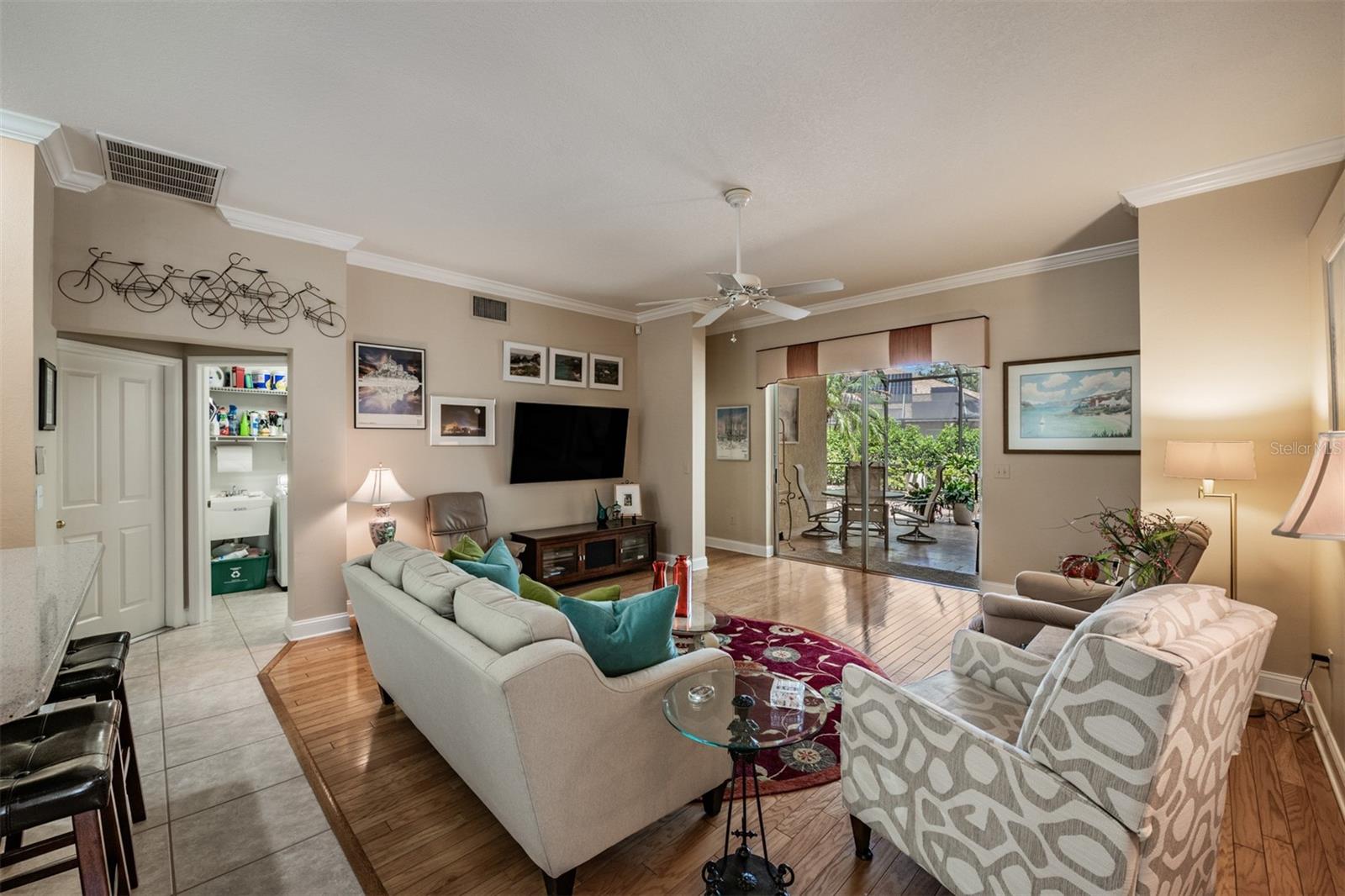 Family Room, open and spacious from the kitchen and to the outdoor extensive patio. Hardwood Floors, crown molding, ceiling fan.