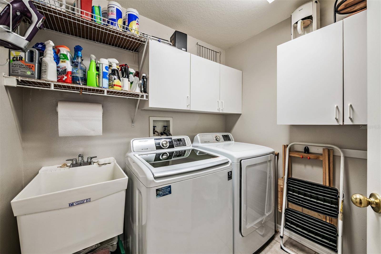 Laundry room with sink, washer and dryer stay.