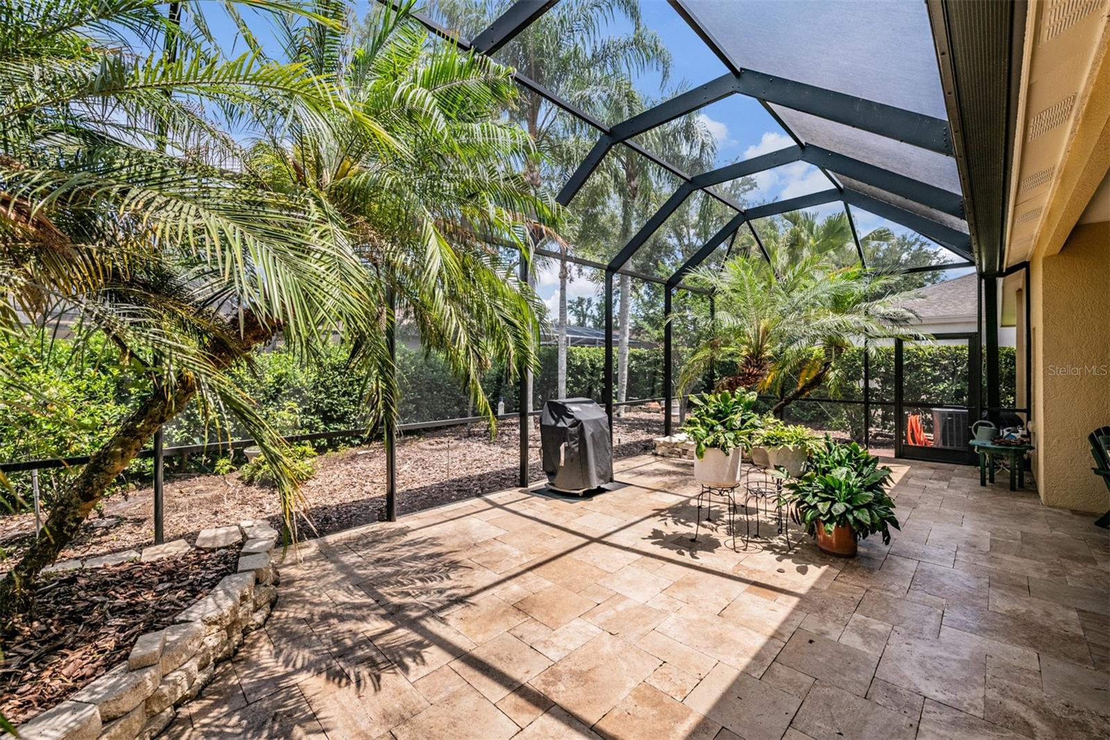 Stunning outdoor screened and covered addition with pavers.