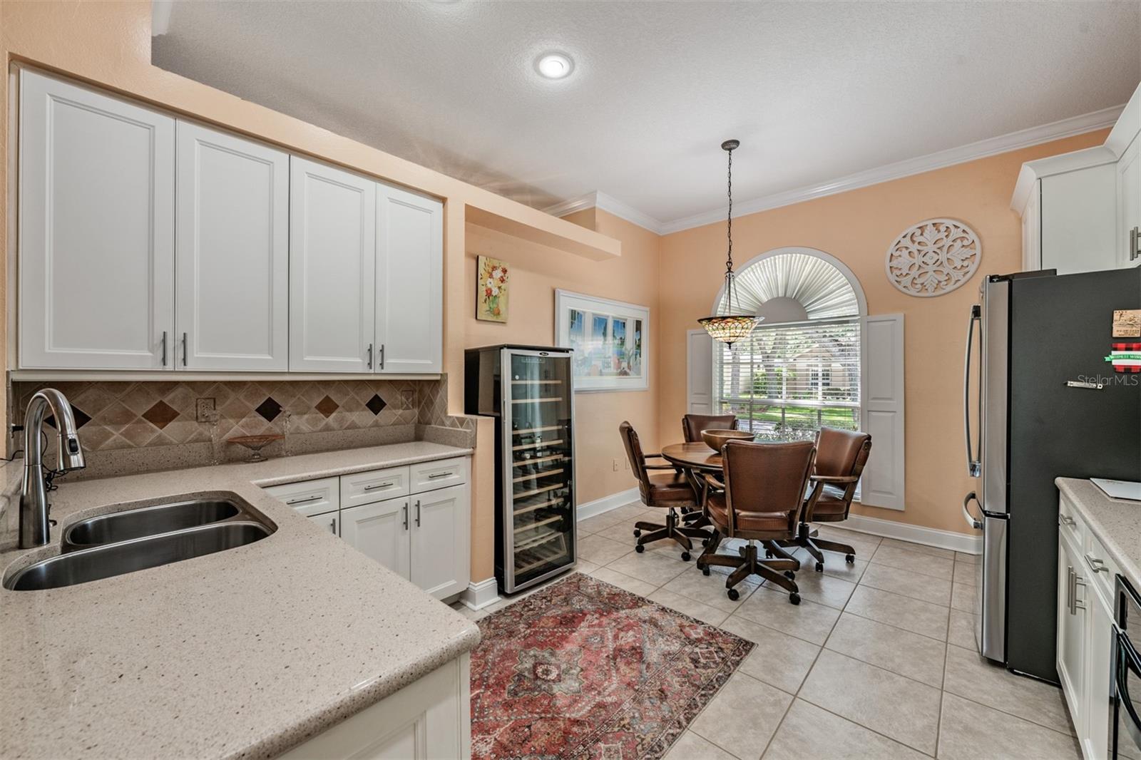 Open Kitchen to the Family Room, Stone Countertops, Stainless Steel Appliances, Gas Range, Tile Flooring, Inset Lighting and lots of sunlight.