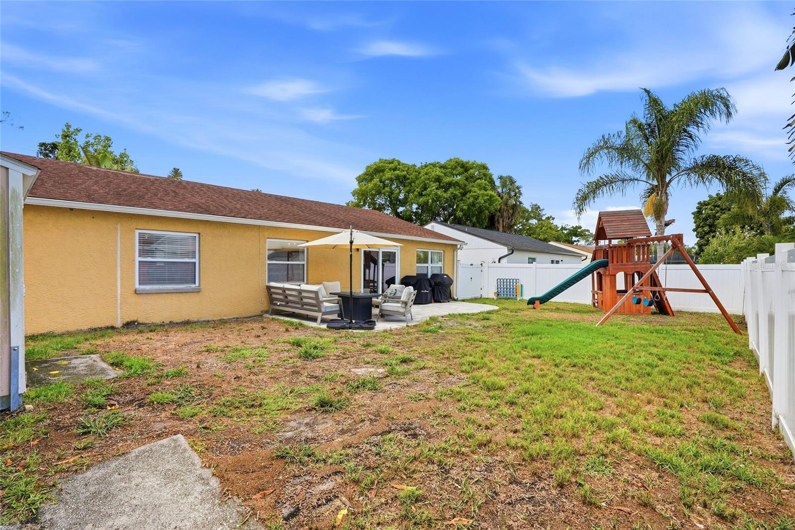 Your fully fenced backyard complete with paver patio, shed and playground!