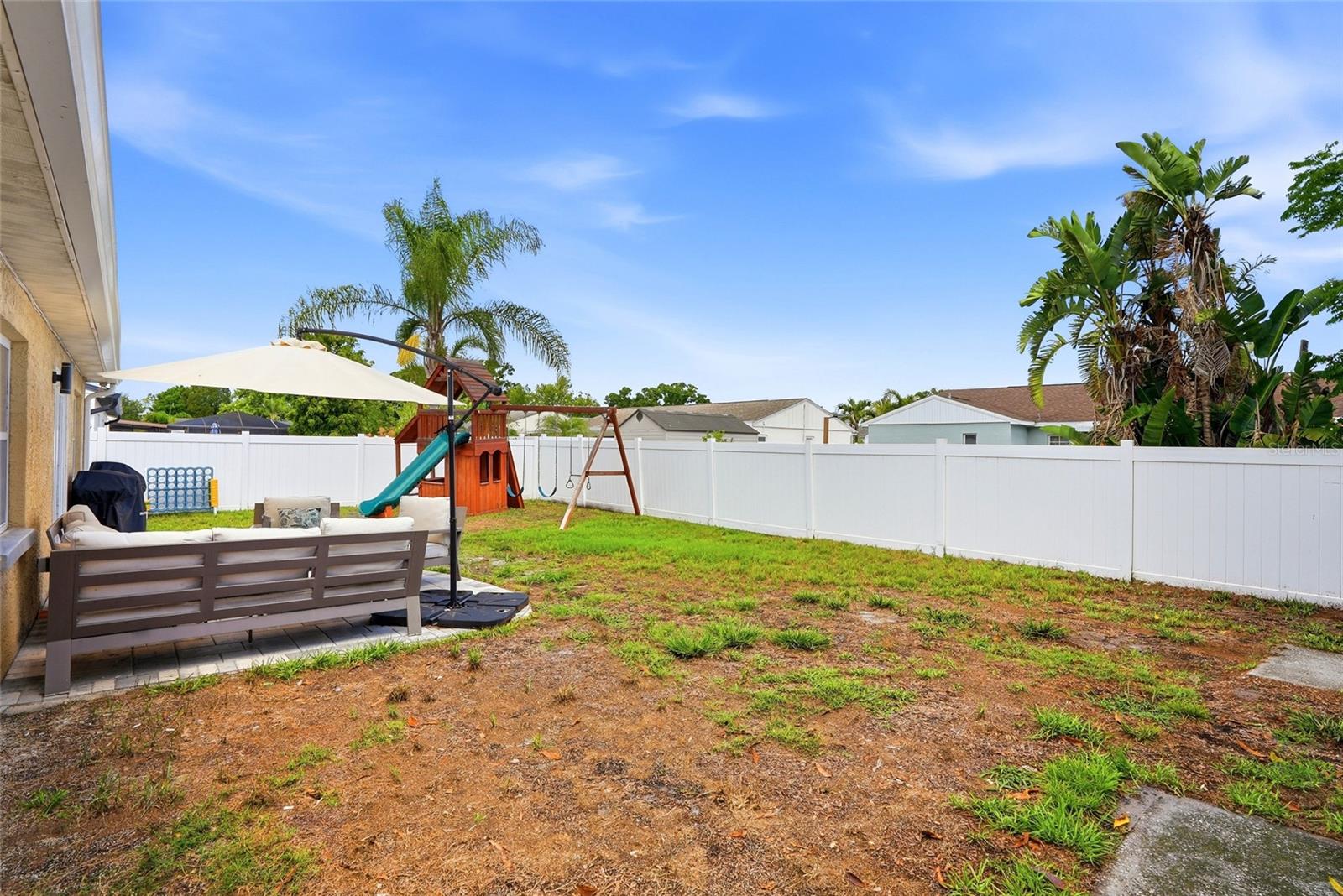 Your fully fenced backyard complete with paver patio, shed and playground!
