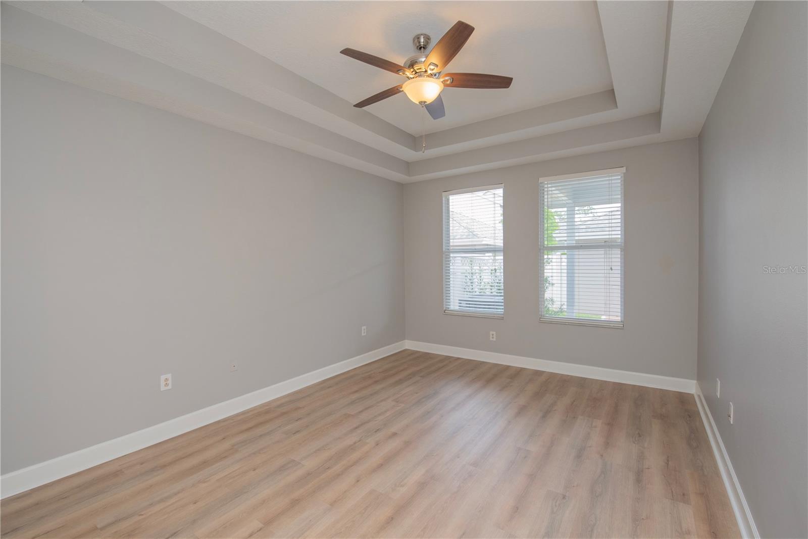 Primary bedroom with double tray ceiling.