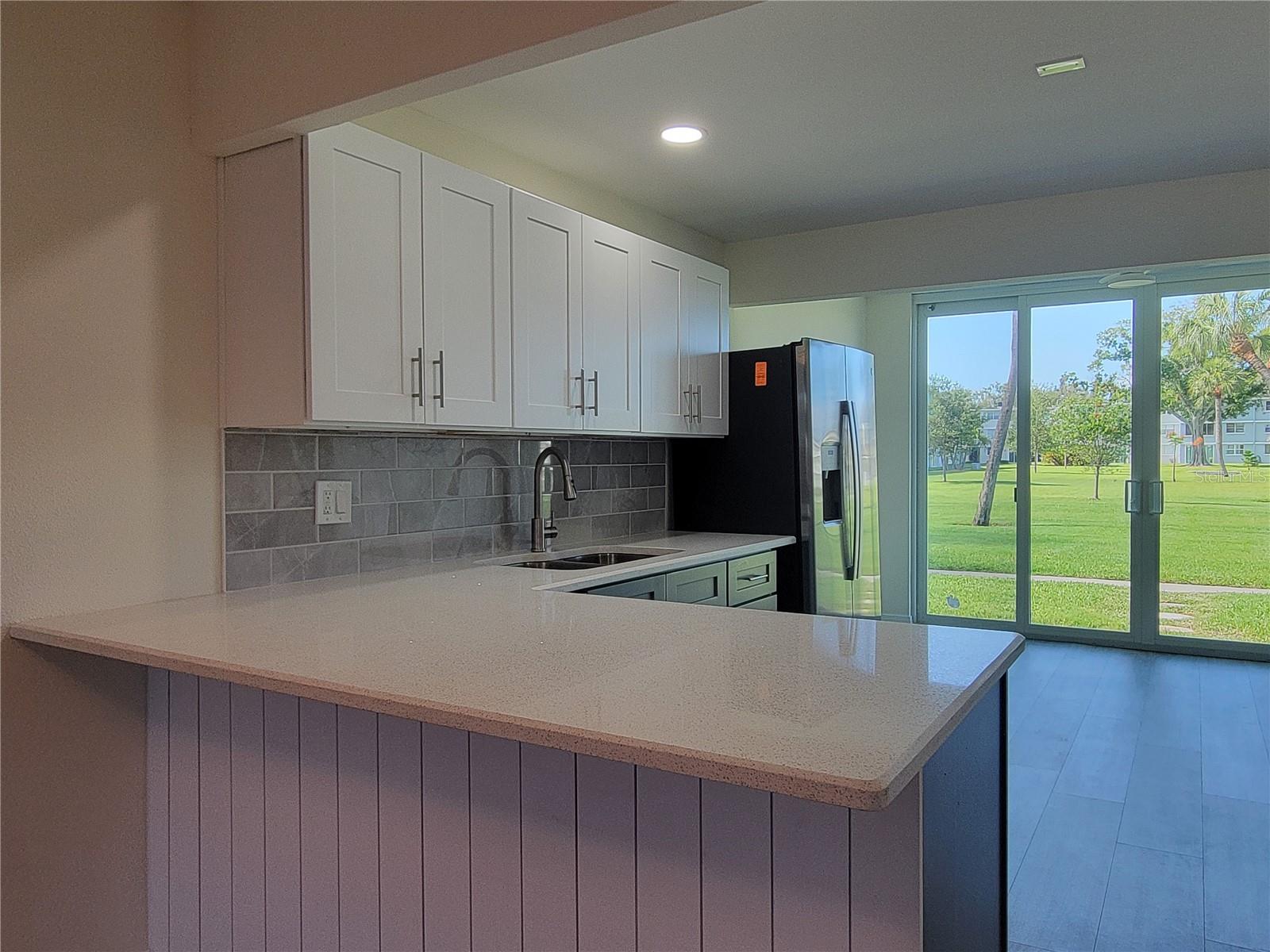 Renovated kitchen from floor to ceiling with spacious breakfast bar.