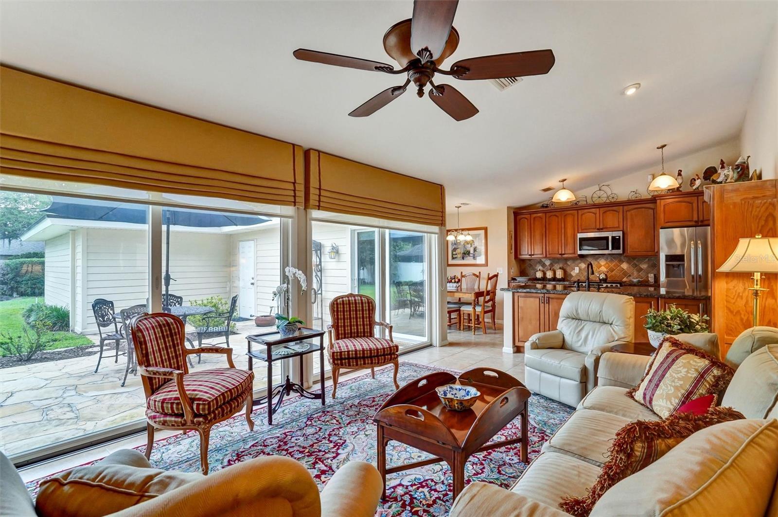 Family room overlooks large luxury stone patio and fenced back yard.