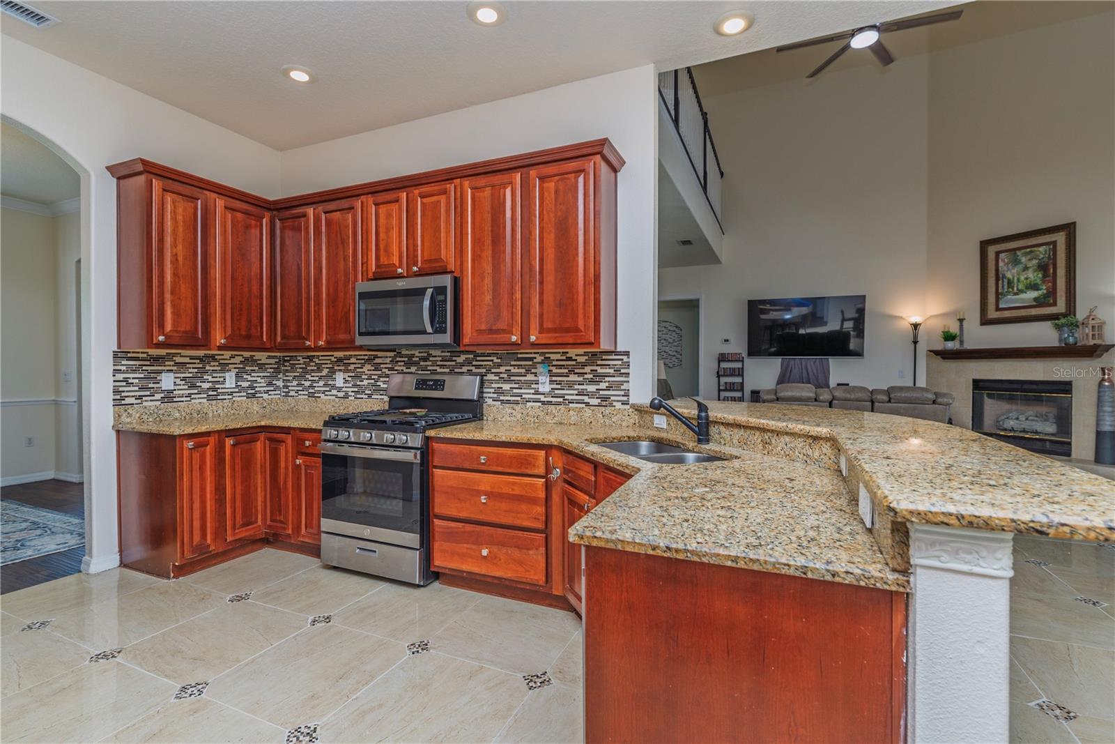 Kitchen with stainless steel applainces and granite countertops.