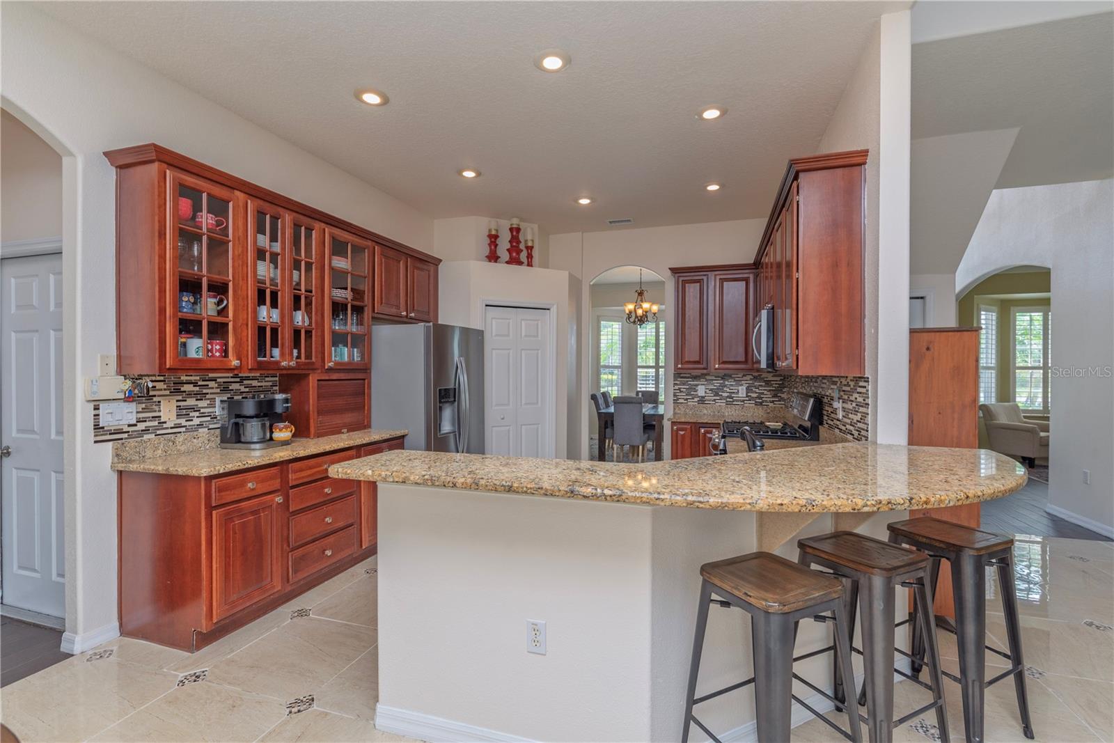 Modern kitchen featuring a breakfast bar with stools.