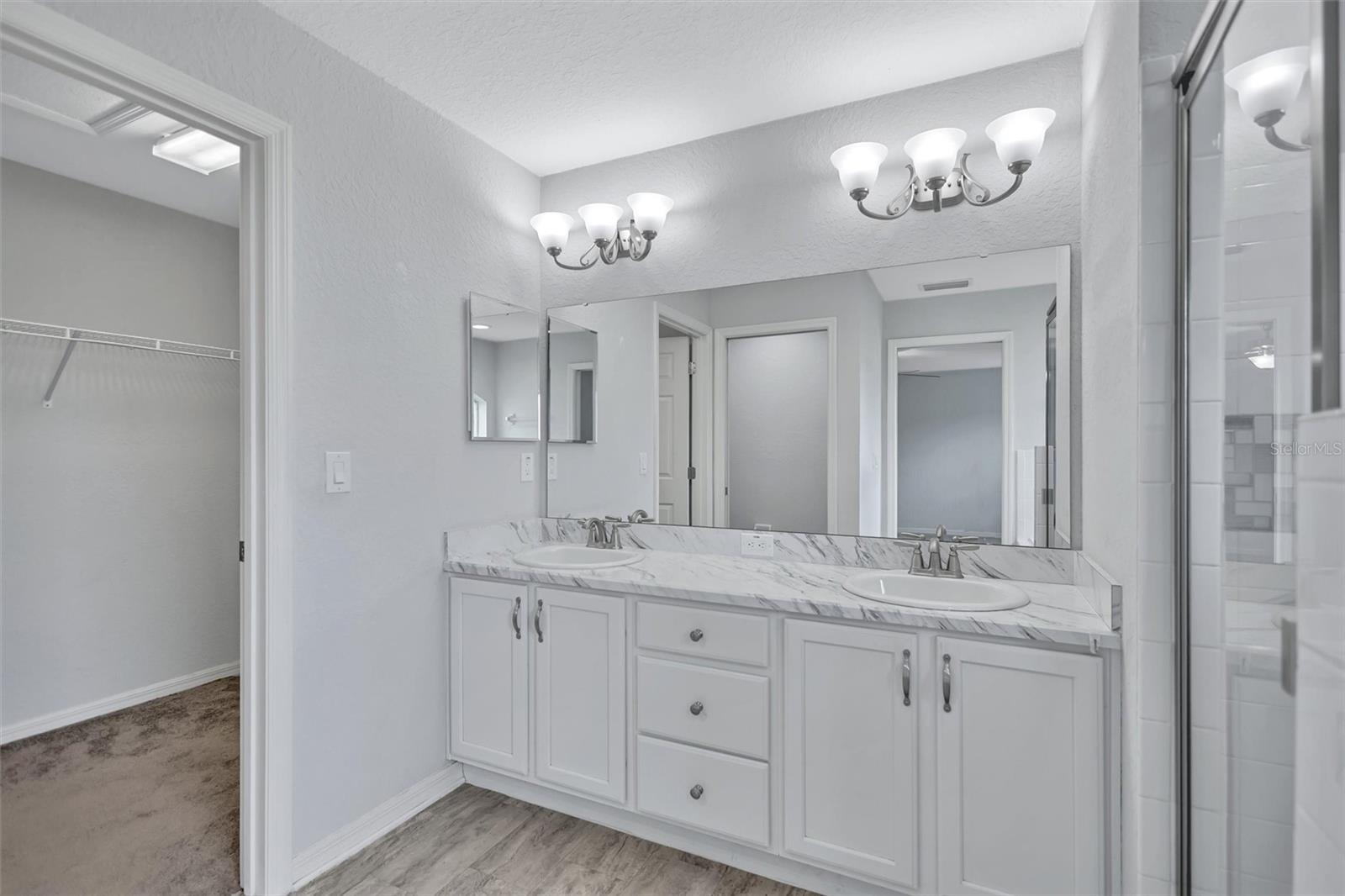 Primary EnSuite featuring Dual Sinks and Walk-In Closet