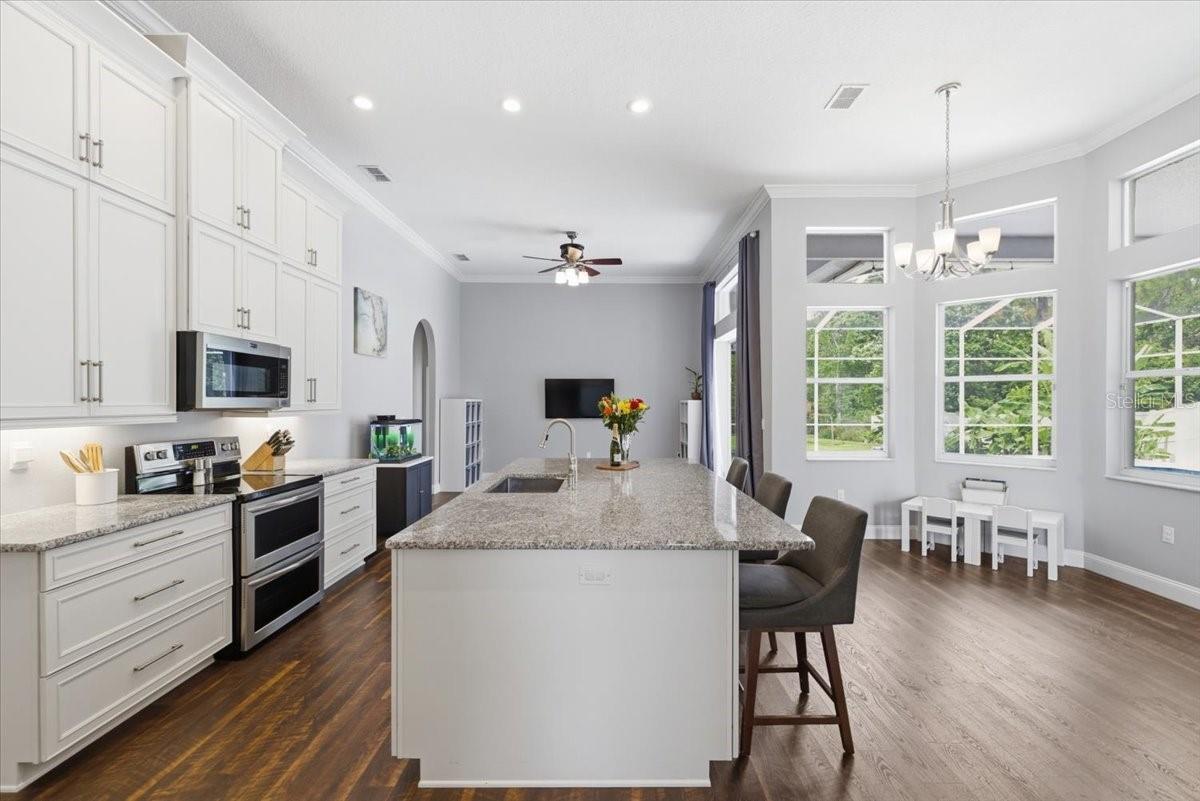 Kitchen with custom cabinents, crown molding, LVP, tons of storage, and custom pantry organization built in system.