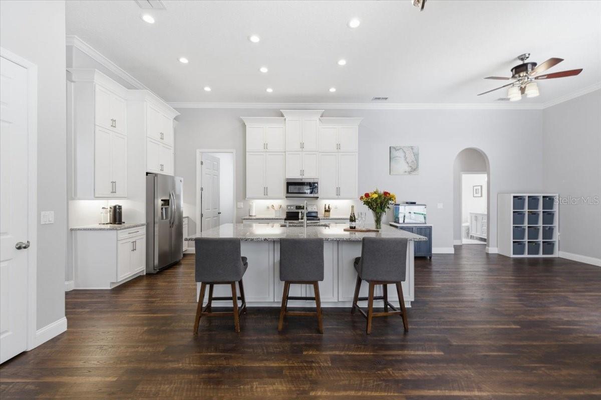 Kitchen with custom cabinents, crown molding, LVP, tons of storage, and custom pantry organization built in system.