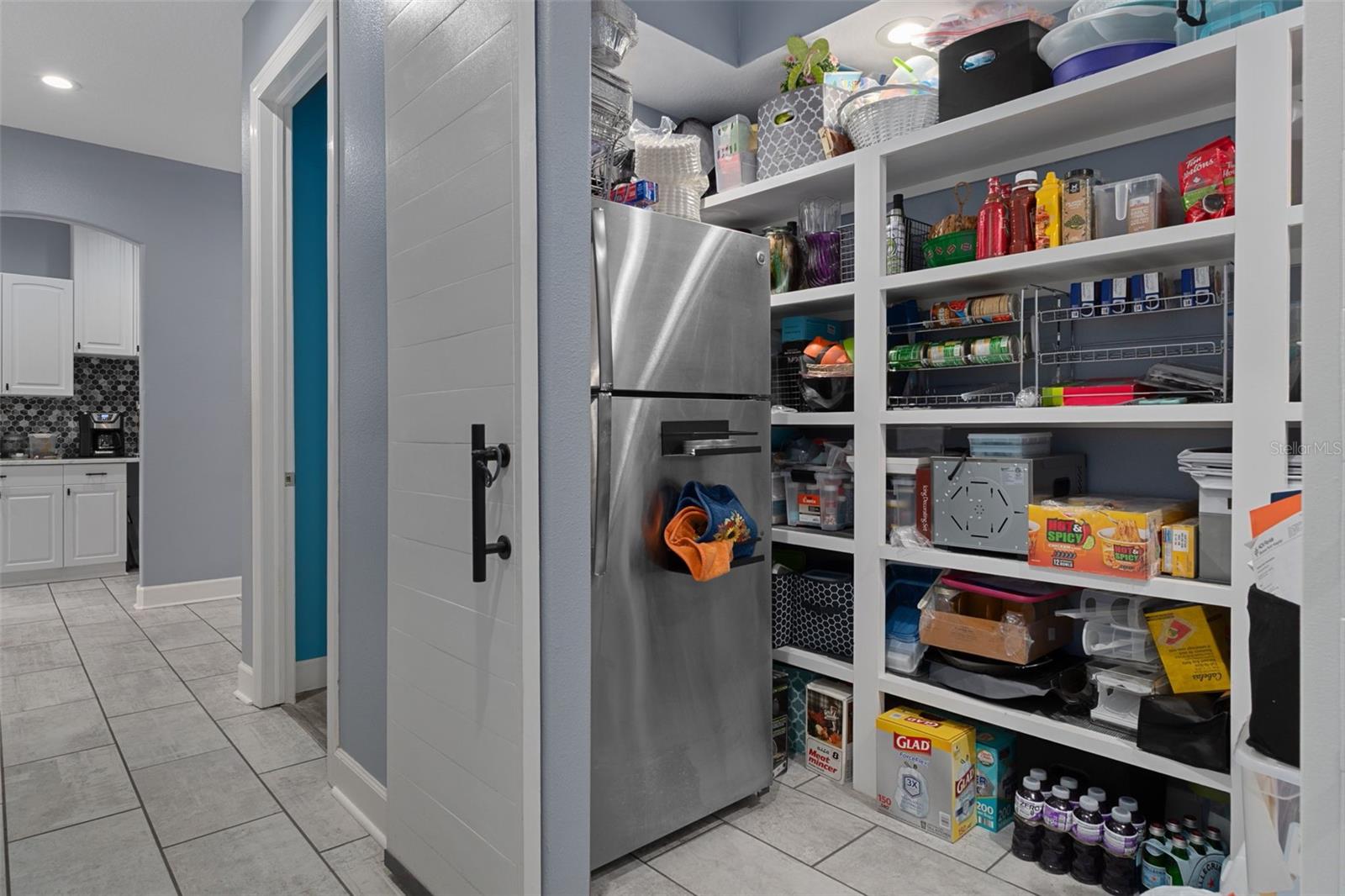 Oversize hall pantry with barn doors.  Could easily be a craft room, office or anything you can imagine.