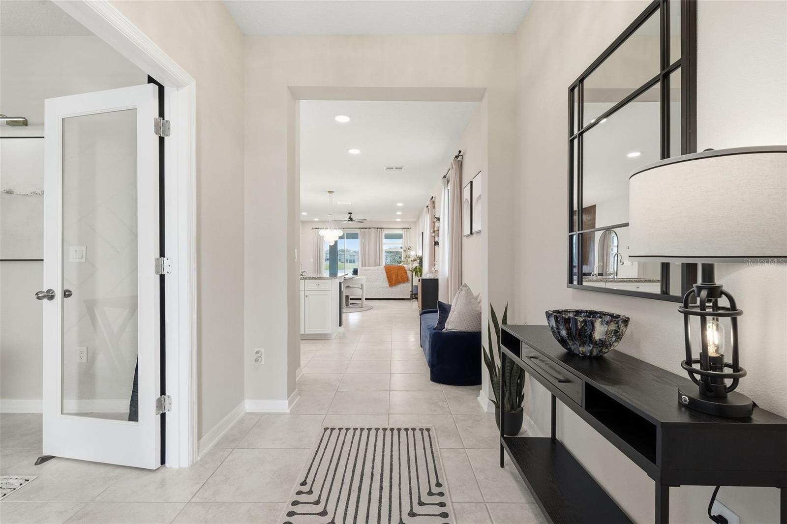 Foyer, flex room / den with double french doors to the left