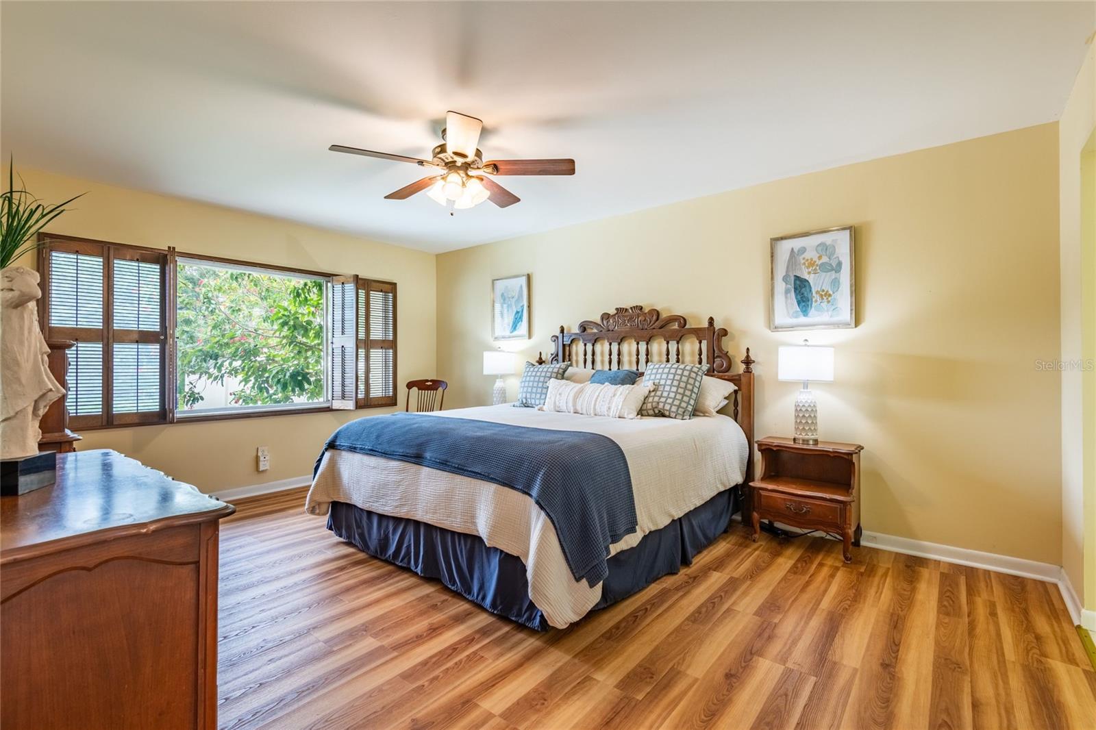 Large Primary bedroom with a view of the pool and lake.