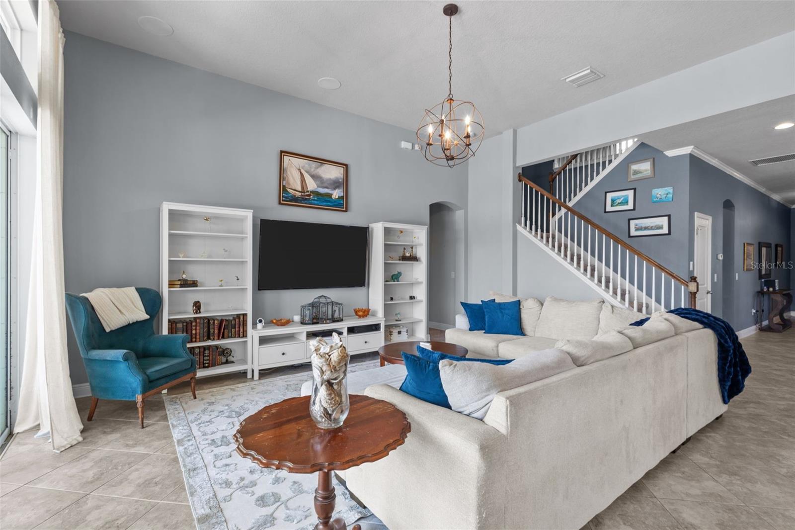 Large gathering room connects seamlessly to the kitchen, dining, and covered patio